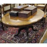 A Victorian oval crossbanded walnut  veneered snaptop oval table, on four carved columns and feet,