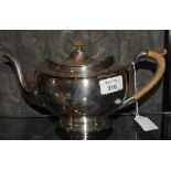 A silver plated tea pot with single foot