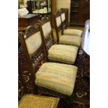Four late Victorian dining chairs with padded spindle turned backs, ring turned legs and castors