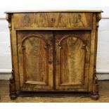 A mahogany veneered serpentine top side cabinet with two doors, two shelves and curved top drawer,