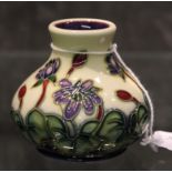 Moorcroft miniature vase with floral pattern on a cream background