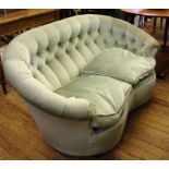 A two-seater settee with light green upholstery, 150cm wide