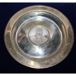 A small silver dish with a Churchill commemorative medallion