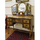 A burr walnut dressing table with serpentine front, five drawers and a three piece adjustable back