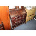 A GEORGIAN MAHOGANY BUREAU the fall front opening to reveal drawers and pigeon holes all above