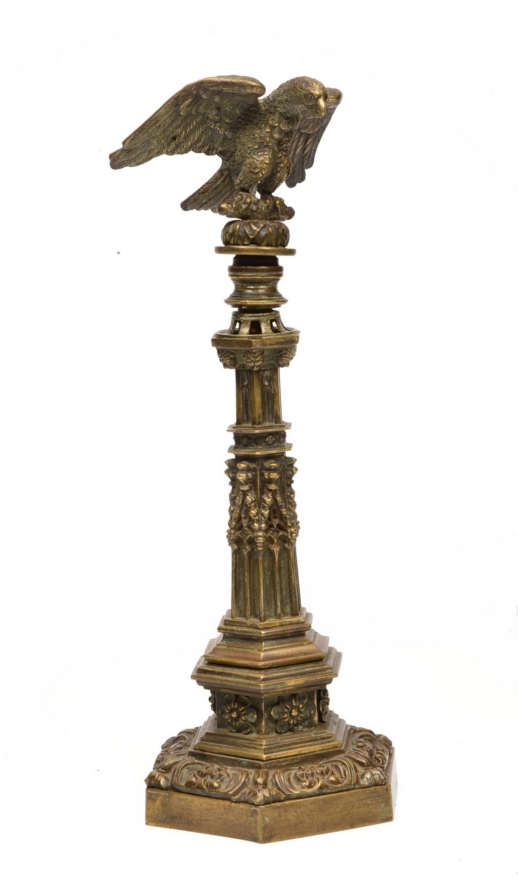 A BRASS ORNAMENT in the form of a bugle perched on top of a Gothic column, all on hexagonal