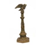 A BRASS ORNAMENT in the form of a bugle perched on top of a Gothic column, all on hexagonal
