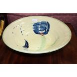 A TIN GLAZED TERRACOTTA BOWL by Jane Bowren, abstract splashes in colour on a cream ground, 39cm