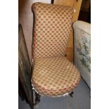 A LATE 19TH CENTURY UPHOLSTERED NURSING CHAIR with turned legs and brass castors 99cm in height