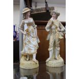 A PAIR OF 20TH CENTURY CONTINENTAL PORCELAIN LARGE FIGURES, a gentleman in a hat with a frilly