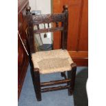 A COUNTRY MADE RUSH SEATED CHILD'S CHAIR with carved top rail standing on square section legs united