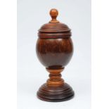 A COCONUT CUP with turned wooden cover and standing on turned circular base, 26cm tall