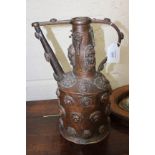 AN ANTIQUE MIDDLE EASTERN COPPER EWER set with masked head decoration, approximately 36cm tall