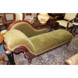 A VICTORIAN GREEN DRALON UPHOLSTERED CHAISE LONGUE with pierced and carved back and standing on