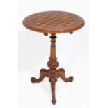 A VICTORIAN WALNUT CIRCULAR TILT TOP CHESS TABLE with decorative inlay and the carved column support