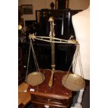 A PAIR OF BRASS SCALES by Degrave, Short, Banner & Co. , London with tripod base 56cm high