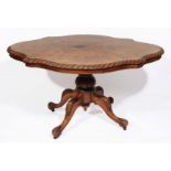 A VICTORIAN WALNUT LOO TABLE with shaped top with rope twist edge standing on turned and carved