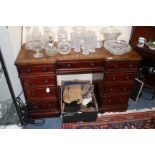 A VICTORIAN MAHOGANY BREAK FRONT PEDESTAL DESK with leatherette inset top over three drawers,