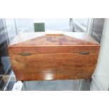 A REGENCY YEW WOOD TEA CADDY of sarcophagus form with fitted interior and lion mask ring handles and