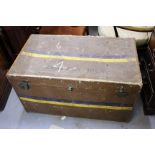 AN OLD BROWN TRAVELLING TRUNK of rectangular form containing a number of various textiles, a