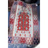 A MODERN KILIM with central red ground motif and further bands of triangular decoration, 167cm x