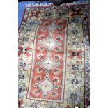 A TURKISH MELAS RUG with four central diamond motifs within a geometric banded border, 202cm x