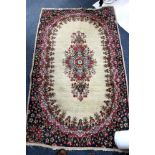 A CREAM GROUND RUG with geometric motifs within a multiple banded border, 189 x 124cm together