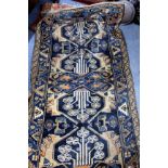 A MODERN BLUE GROUND ORIENTAL RUG with central geometric floral decoration within a banded border,