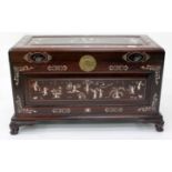 A SMALL ORIENTAL HARDWOOD CHEST with decorative bone inlay standing on carved mask and paw feet,