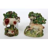 A GEORGE III STAFFORDSHIRE POTTERY FIGURE of a ram with a lamb with bocage above, 11cm high together