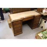 AN EDWARDIAN MAHOGANY BREAK FRONT PEDESTAL DESK with leather inset top and various drawers with ring