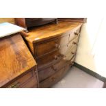 A VICTORIAN MAHOGANY BOW FRONTED CHEST of two short and three long drawers with turned knob