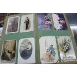 A LARGE ALBUM of early 20th Century post cards of various themes to include Easter, the First