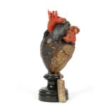 A MID 19TH CENTURY PRESERVED HUMAN HEART with painted wax covering mounted on a turned ebonised