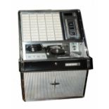 A ROCK-OLA 430 STEREOPHONIC JUKE BOX holding fifty singles and standing on original chromium