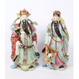 TWO LARGE CHINESE MALE PORCELAIN FIGURES each with long black beards and traditional clothing,