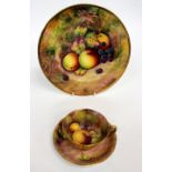 A PORCELAIN PLATE painted by Richard Budd depicting apples and blackberries by a mossy bank,