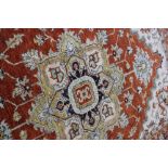 A PAKISTANI BROWN GROUND RUG with central diamond motif and stylised floral decoration within a