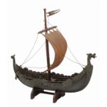 AN OLD CAST BRONZE MODEL OF A VIKING LONG BOAT with shields hung down the side and in full sale, the