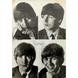 AN AUTOGRAPHED PHOTO OF THE BEATLES signed (?) by all four members, the back and white image divided