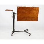 A FOOTS PATENT BLACK PAINTED CAST IRON READING STAND with wooden writing surfaces and further