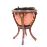 A VICTORIAN COPPER AND OAK COAL BUCKET and stand, the bucket with looping brass handle, the stand