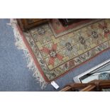 A TURKISH MELAS RUG with four central diamond motifs within a geometric banded border, 202cm x