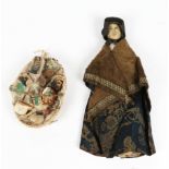 AN EARLY TO MID 19TH CENTURY PEDLAR DOLL with moulded and painted kid leather face and wearing a