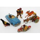 A GERMAN TIN PLATE TOY 'GALLOP 852' COWBOY and a cart being towed by a zebra and printed with the