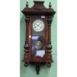 A CONTINENTAL ROSEWOOD WALL CLOCK the cream dial and chapter ring with black Roman numerals, the