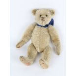 AN EARLY 20TH CENTURY STEIFF STRAW FILLED MOHAIR TEDDY BEAR, 33cm in length