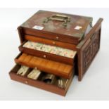 AN EARLY TO MID 20TH CENTURY CHINESE MAHJONG SET in a metal bound chest of five drawers