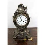 A CONTINENTAL MANTLE CLOCK the silvered acanthus leaf scrolling case with white enamel dial with