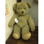 AN OLD PLUSH TEDDY BEAR with jointed arms and legs